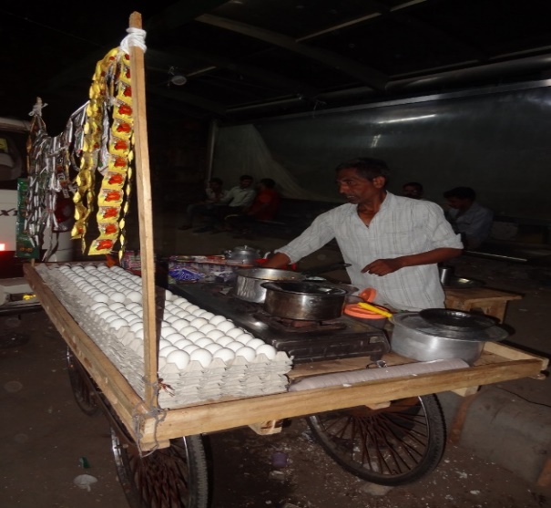 A vendor at his food cart